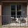 One-Bedroom Luxury Apartments in North Raleigh, NC - Aventon Nora - Private Patio with Guardrails, a Light Fixture, and Two Patio Chairs with a Table