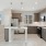 modern apartment kitchen featuring quartz countertops, an island, and stainless steel appliances