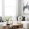 modern white couch and wood coffee table with vases and books