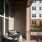 two black chairs and small white table outside on an apartment patio