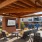 1-Bedroom Luxury Apartments in North Raleigh, NC - Aventon Nora - Al Fresco Dining Pavilion with Bistro Seating, Mounted TV and Lush Landscaping 